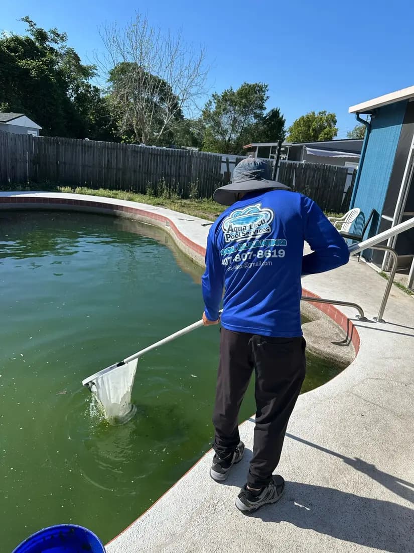Aqua Lecu pool technician cleaning a residential pool in Orlando Florida